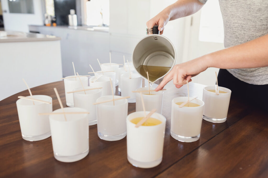 pouring wax into candle jars candle making process