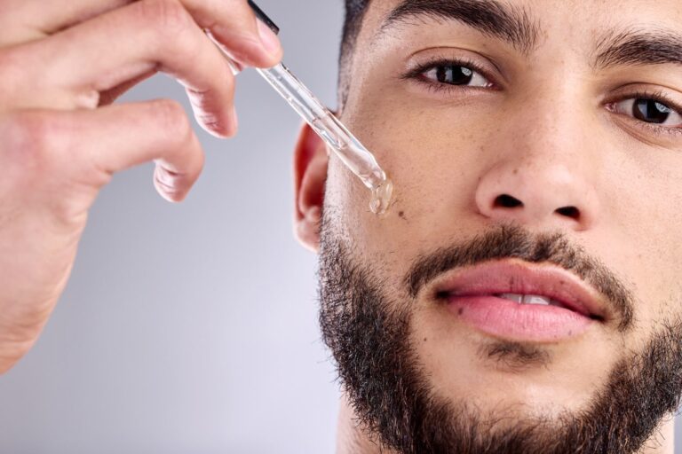 applying beard oil from dropper bottle[1]